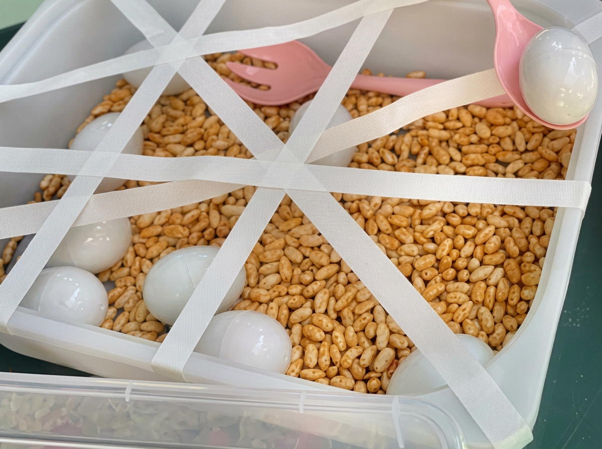 Toddler scooping rice and eggs